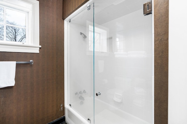 full bathroom featuring bath / shower combo with glass door