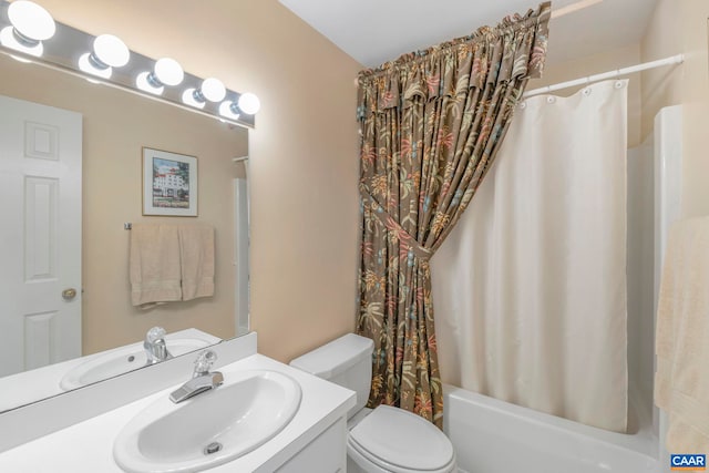 bathroom featuring shower / bath combo, vanity, and toilet