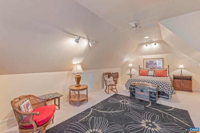 bedroom with lofted ceiling, track lighting, baseboards, and carpet flooring