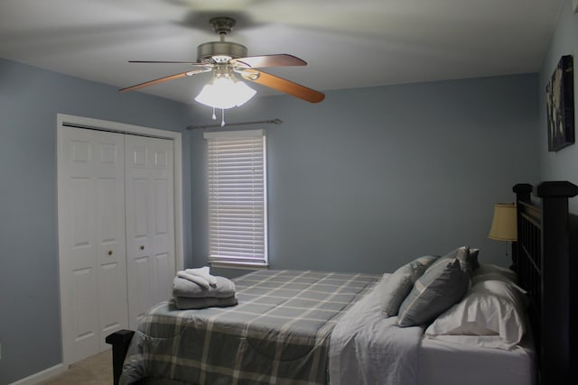 carpeted bedroom with ceiling fan and a closet