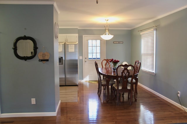 dining area with crown molding and dark hardwood / wood-style floors