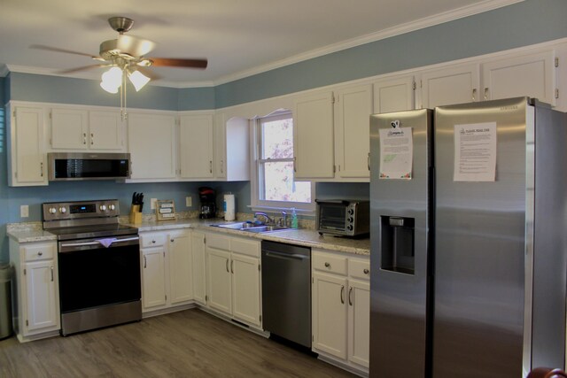 kitchen featuring appliances with stainless steel finishes, sink, and white cabinets