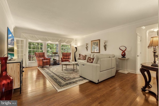 living area with crown molding and dark wood-style flooring