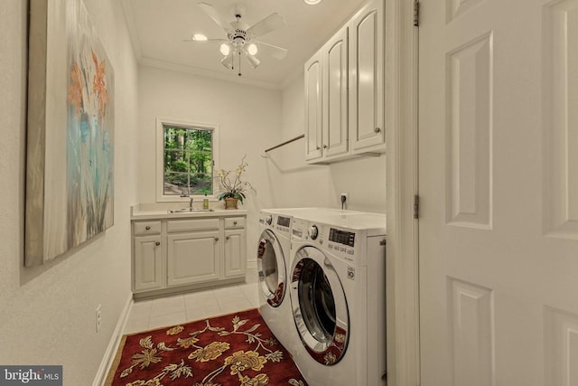 washroom featuring separate washer and dryer, baseboards, light tile patterned flooring, and cabinet space