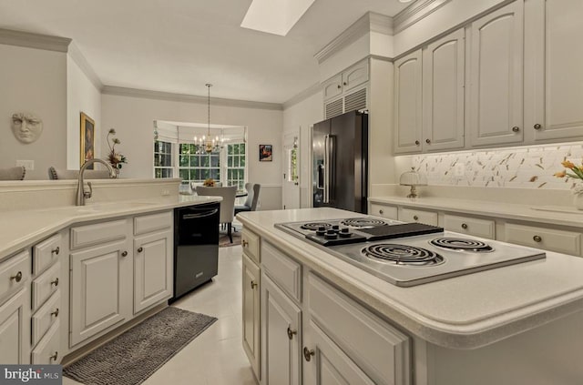 kitchen with a sink, black dishwasher, stainless steel electric stovetop, high end refrigerator, and a skylight