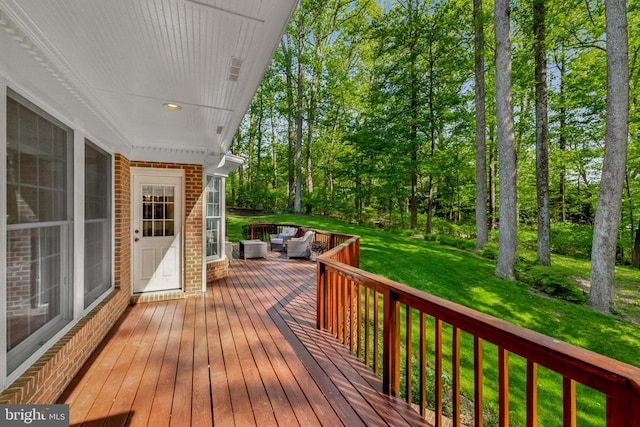 wooden terrace with a lawn and outdoor lounge area