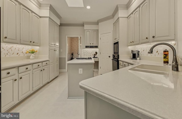 kitchen with a kitchen island, crown molding, tasteful backsplash, a sink, and recessed lighting