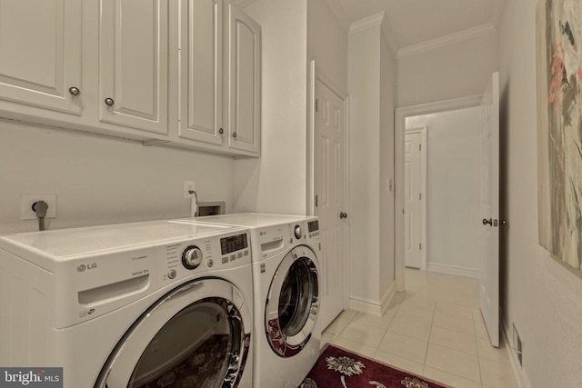 washroom with separate washer and dryer, ornamental molding, cabinet space, and light tile patterned floors