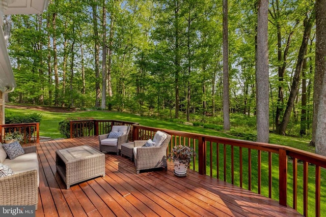 wooden terrace featuring a lawn and an outdoor hangout area