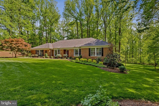 ranch-style home with brick siding and a front yard