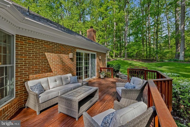 wooden deck with a lawn and outdoor lounge area