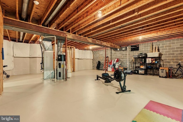 exercise area featuring heating unit and water heater