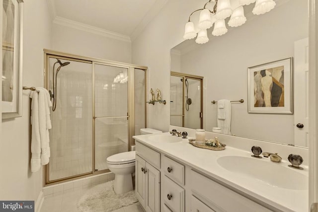 full bathroom featuring crown molding, a stall shower, a sink, toilet, and a chandelier