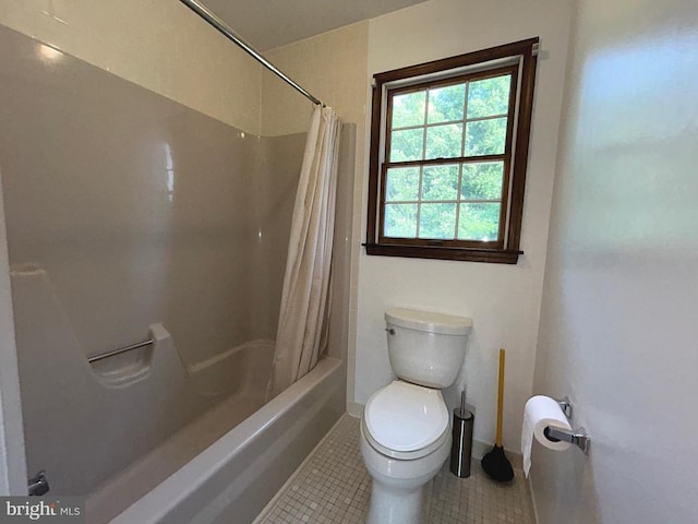 bathroom with tile patterned flooring, shower / bath combo, and toilet