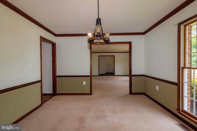 unfurnished room with light carpet, ornamental molding, and a chandelier