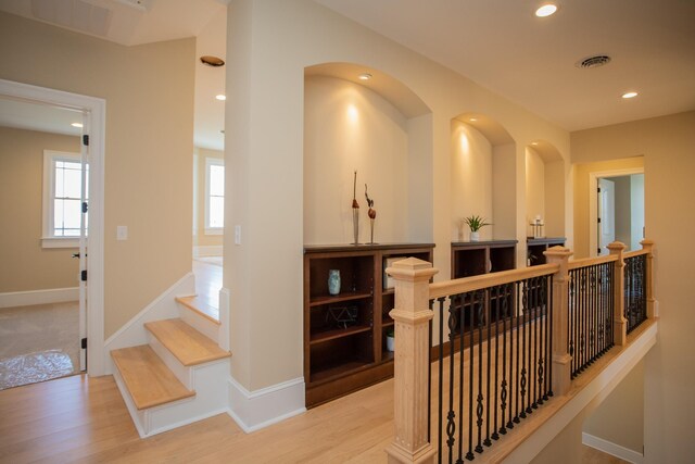 corridor with light hardwood / wood-style flooring