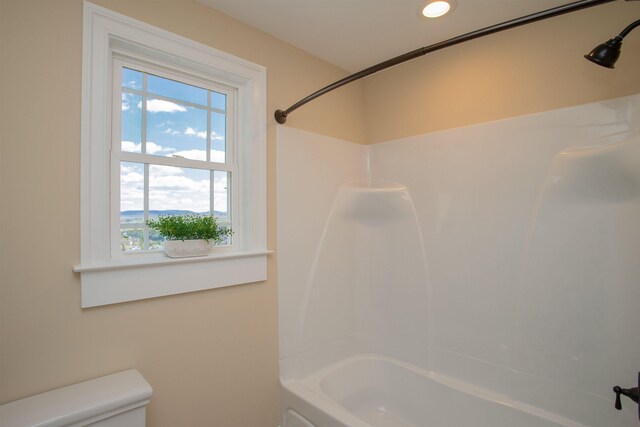 bathroom with shower / bath combination and toilet