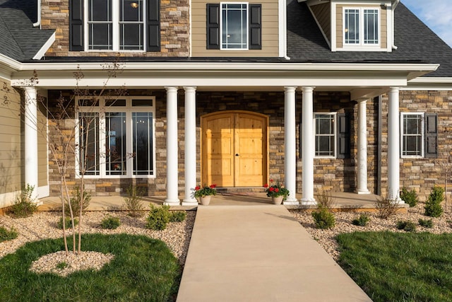 view of exterior entry with a porch