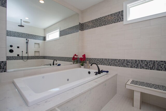 bathroom featuring tile walls and independent shower and bath