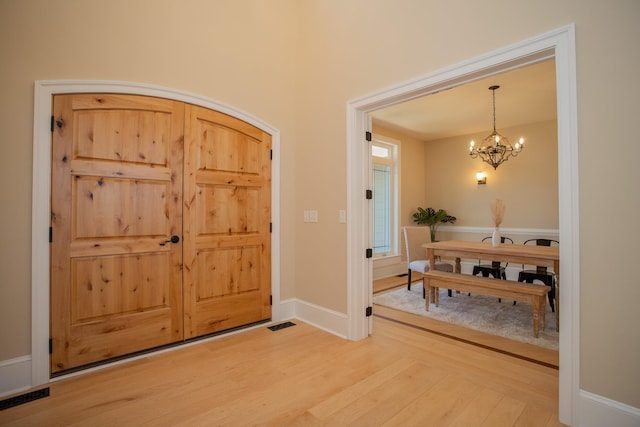 entrance foyer featuring an inviting chandelier