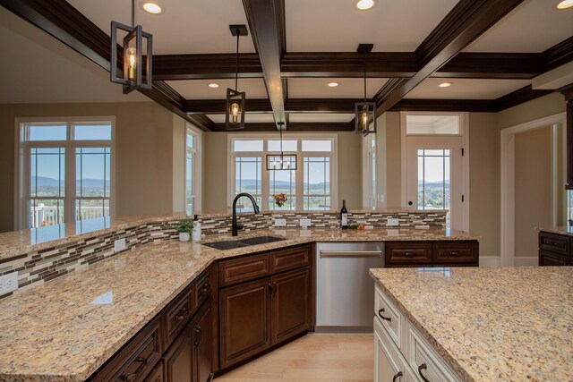 kitchen with sink, hanging light fixtures, light stone countertops, stainless steel dishwasher, and beamed ceiling