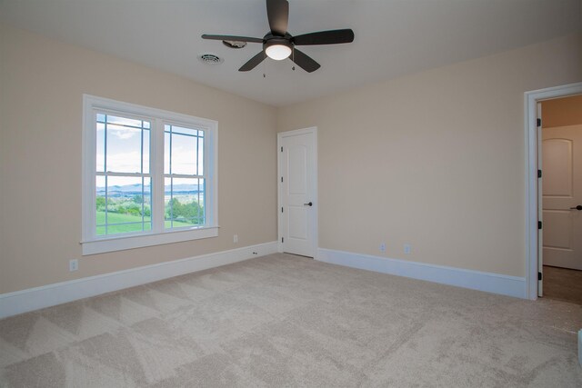 unfurnished room featuring light carpet and ceiling fan