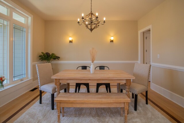 dining space featuring a notable chandelier and light hardwood / wood-style floors