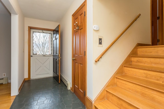 entryway featuring a baseboard radiator, stairway, a baseboard heating unit, stone finish floor, and baseboards