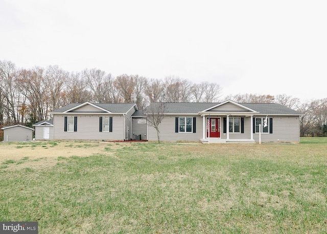 ranch-style house with a front lawn and a storage unit