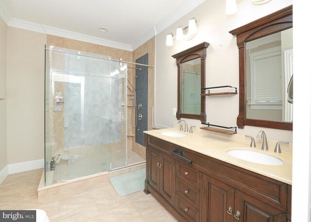 bathroom featuring a shower with door, ornamental molding, tile patterned flooring, and vanity