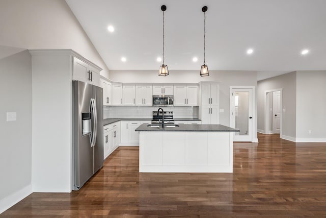 kitchen featuring a kitchen island with sink, pendant lighting, stainless steel appliances, and white cabinets