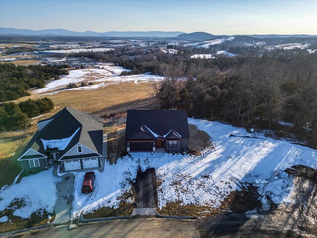 snowy aerial view featuring a mountain view