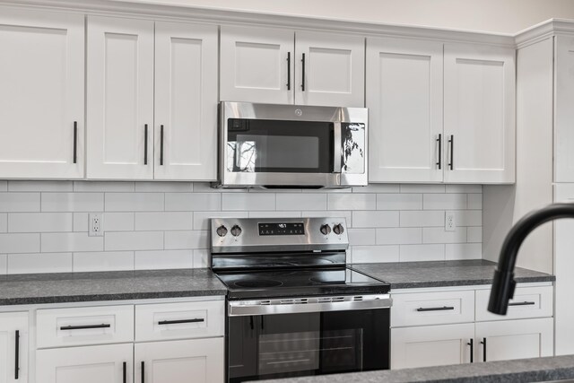 kitchen featuring white cabinetry, appliances with stainless steel finishes, and tasteful backsplash