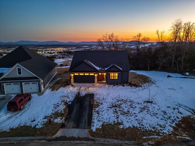 view of front of property with a garage and a mountain view