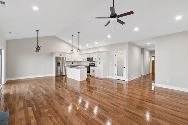 unfurnished living room featuring sink, wood-type flooring, high vaulted ceiling, and ceiling fan