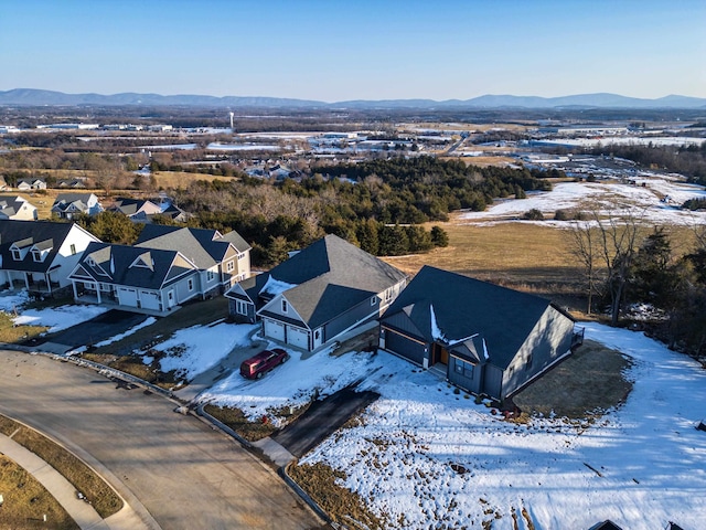 snowy aerial view with a mountain view