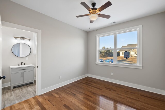 bedroom featuring ensuite bathroom, ceiling fan, and light hardwood / wood-style floors