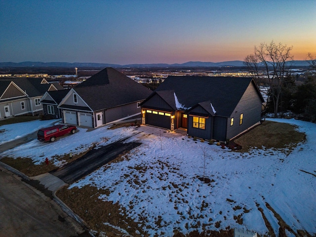 view of front facade featuring a garage and a mountain view