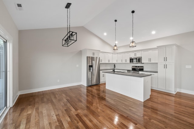 kitchen featuring white cabinetry, decorative light fixtures, dark wood-type flooring, and stainless steel appliances