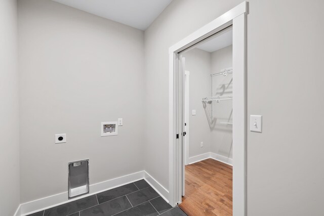 washroom with dark hardwood / wood-style floors, hookup for a washing machine, and electric dryer hookup