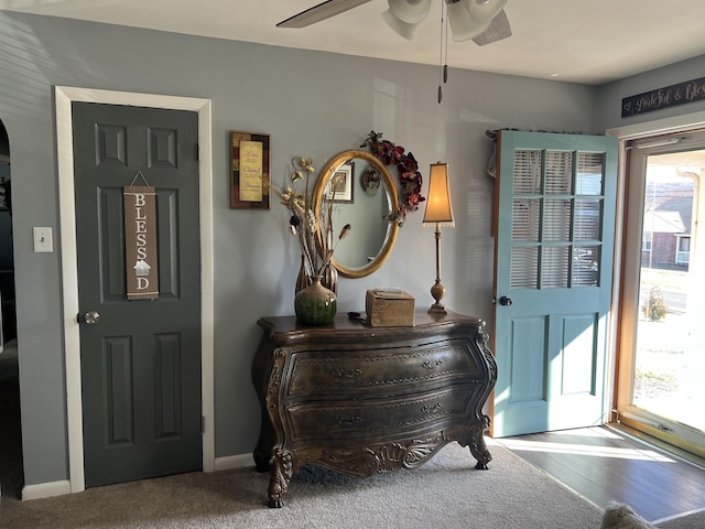 entryway with a ceiling fan and baseboards