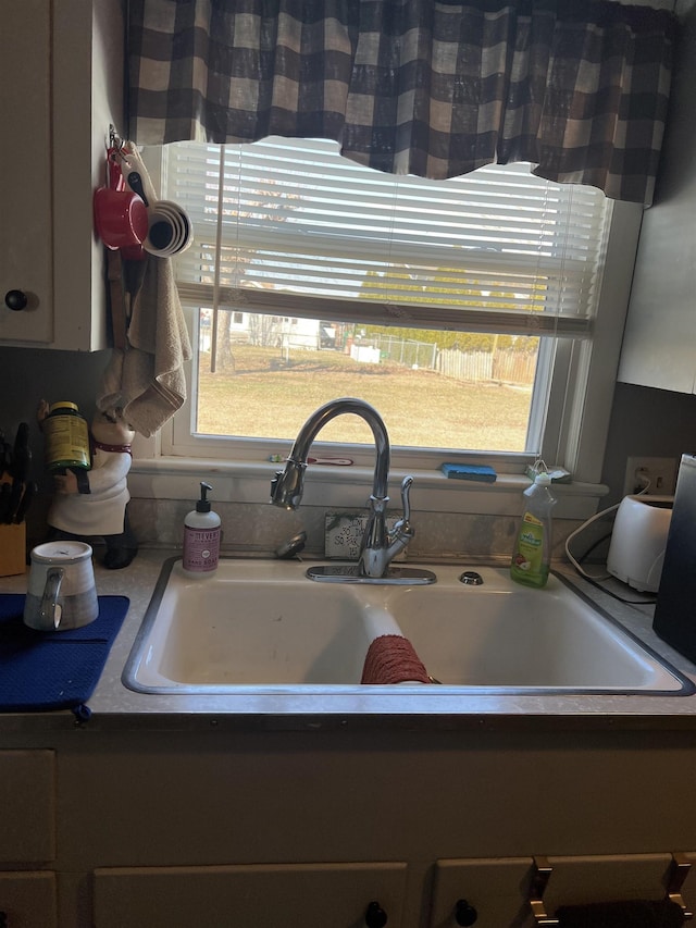 kitchen with a sink and a healthy amount of sunlight