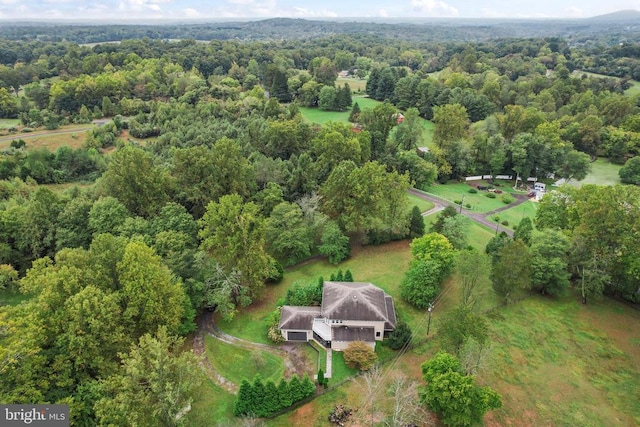 bird's eye view featuring a wooded view