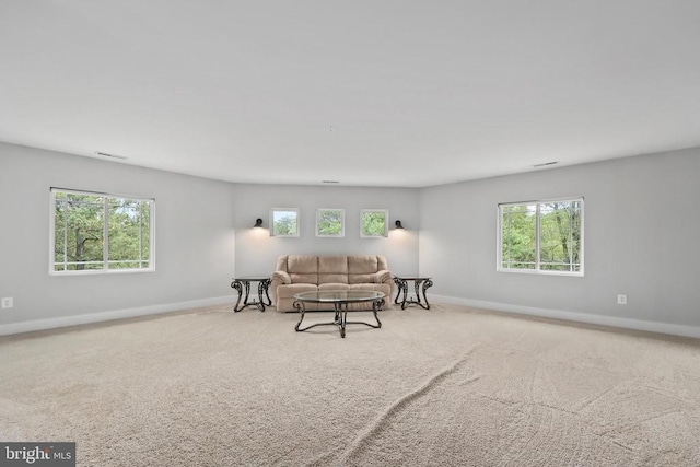 carpeted living room featuring visible vents and baseboards