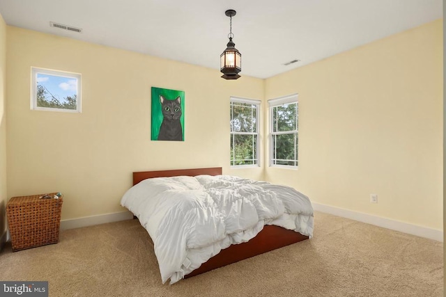 bedroom with baseboards, visible vents, and carpet flooring