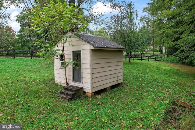 view of shed featuring fence