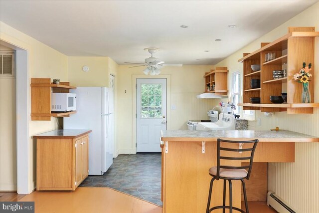 kitchen featuring a ceiling fan, open shelves, baseboard heating, a peninsula, and white appliances