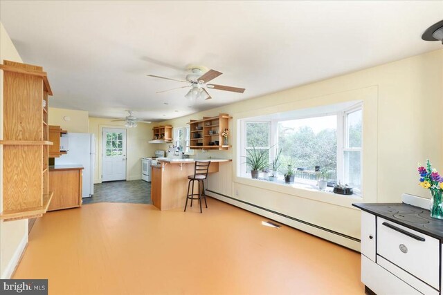 kitchen with open shelves, white appliances, a breakfast bar area, a baseboard heating unit, and a ceiling fan