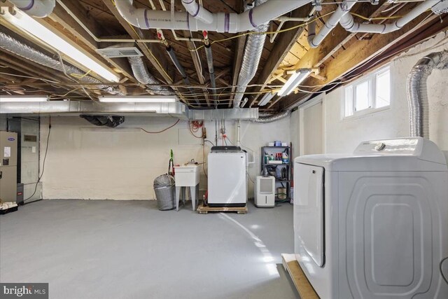 below grade area featuring separate washer and dryer and visible vents
