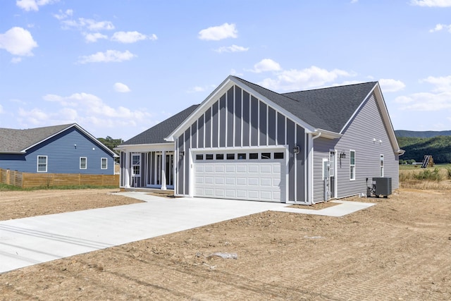 view of front facade featuring a garage and central AC